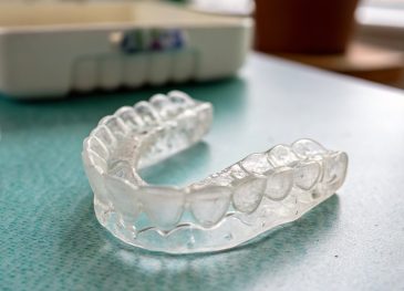 Editorial hero image illustrating 5 Things Retainers Can and Cannot Do When It Comes to Straightening Teeth for a dentist brand.