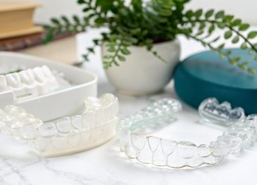 Editorial hero image illustrating Invisalign clinical support vs high-street orthodontic customer service: what patients in Battersea can expect for a dentist brand.